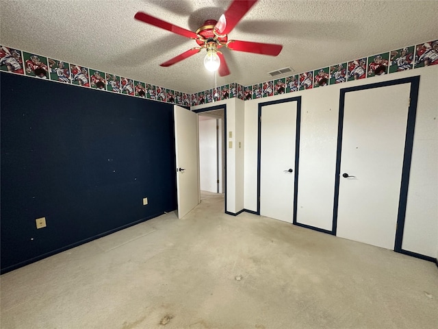 unfurnished bedroom featuring ceiling fan and a textured ceiling