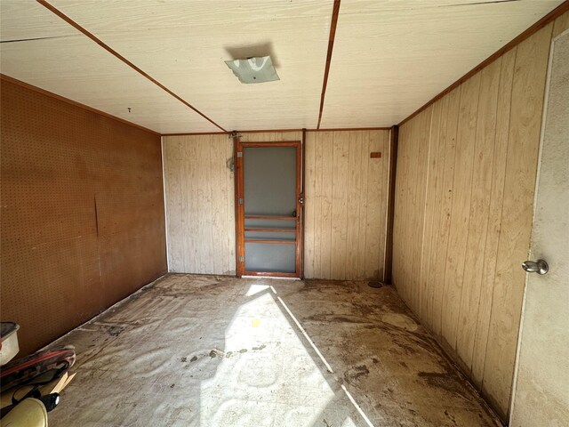 spare room with wooden walls