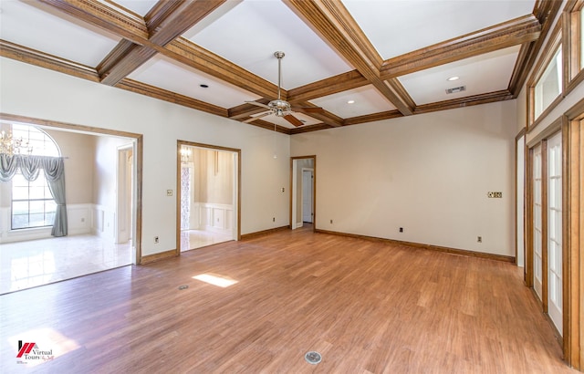 unfurnished room with coffered ceiling, ceiling fan with notable chandelier, crown molding, light hardwood / wood-style flooring, and beamed ceiling