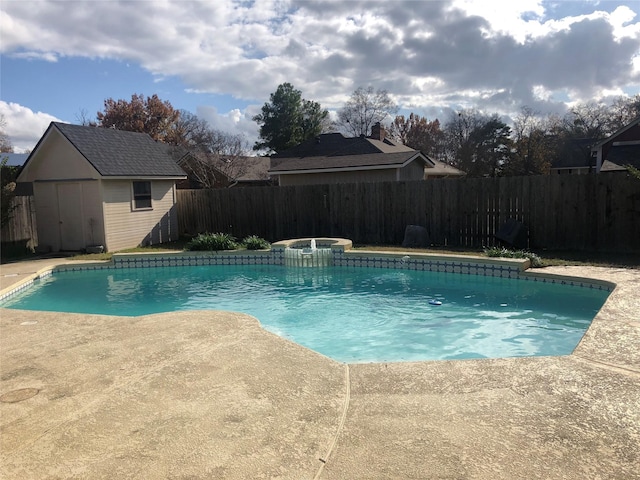 view of pool featuring an in ground hot tub and a shed