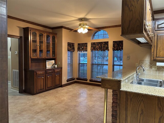 bathroom with tile patterned floors, vanity, ornamental molding, and a shower with door