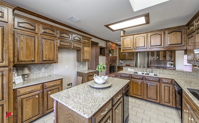 kitchen featuring kitchen peninsula, tasteful backsplash, crown molding, sink, and a kitchen island