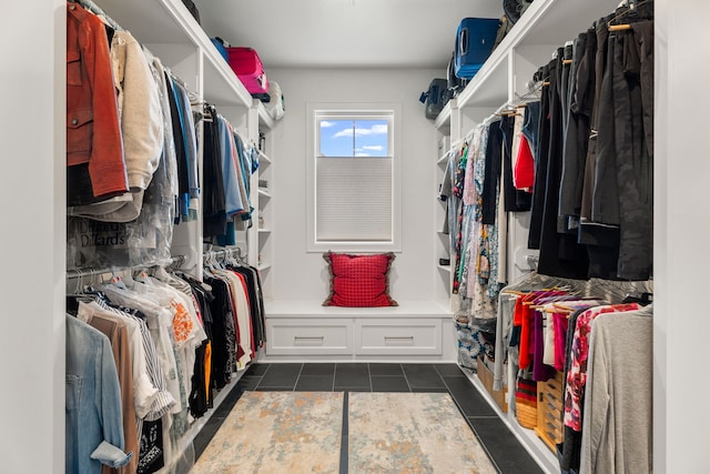 walk in closet featuring dark tile patterned flooring