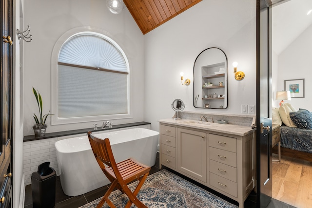 bathroom with hardwood / wood-style floors, vanity, a bathtub, wooden ceiling, and vaulted ceiling