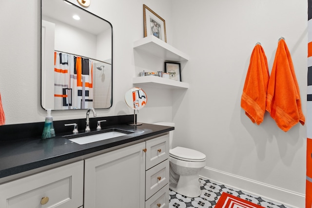 bathroom with vanity, a shower with shower curtain, and toilet