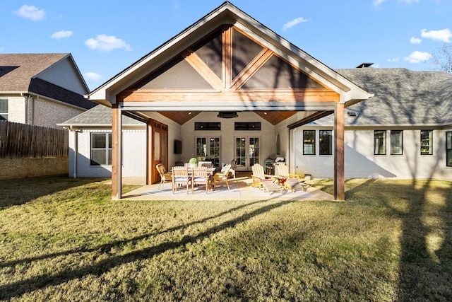 back of house featuring ceiling fan, a patio area, and a lawn