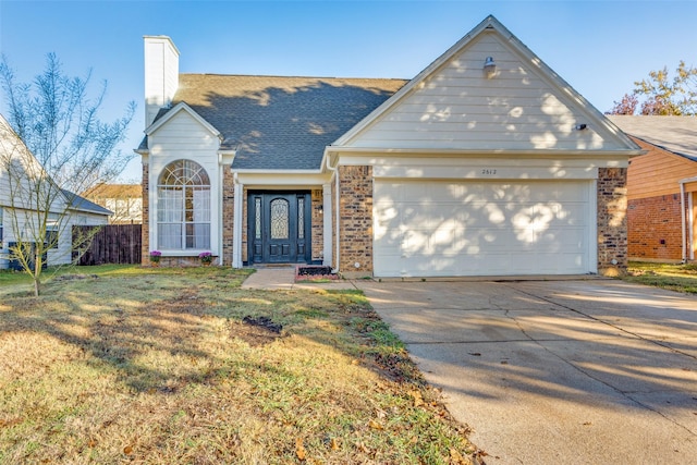 view of front of home featuring a front yard and a garage