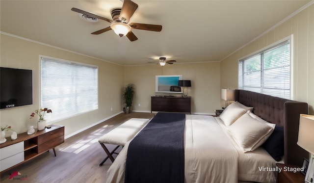 bedroom with ceiling fan, light wood-type flooring, and crown molding