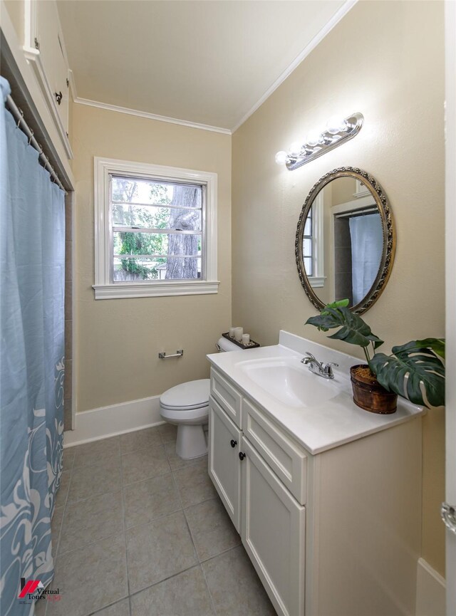 bathroom with toilet, vanity, tile patterned floors, and crown molding