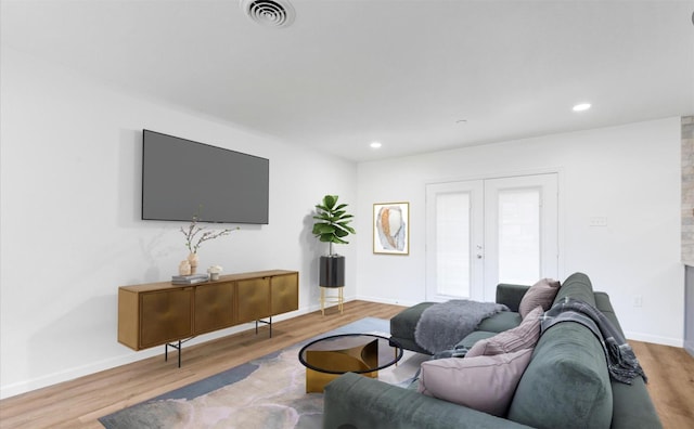 living room featuring wood finished floors, visible vents, baseboards, recessed lighting, and french doors