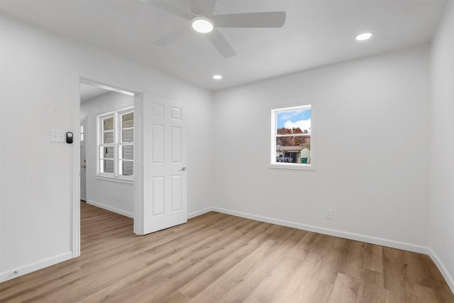 spare room with light hardwood / wood-style floors and ceiling fan