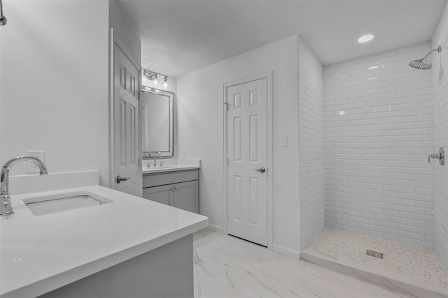 bathroom featuring vanity and tiled shower