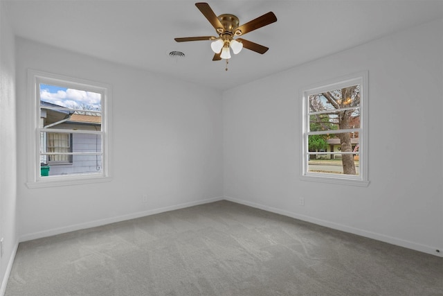 empty room featuring light carpet and ceiling fan