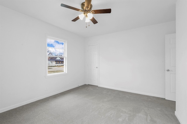 spare room featuring carpet flooring and ceiling fan