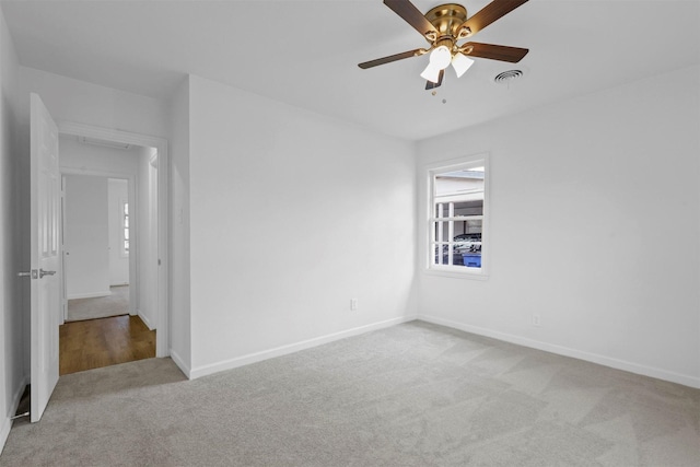 unfurnished room with ceiling fan and light colored carpet