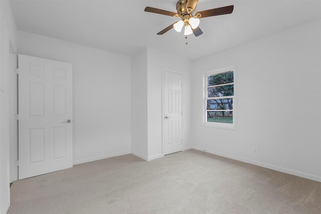 unfurnished bedroom with ceiling fan and light colored carpet