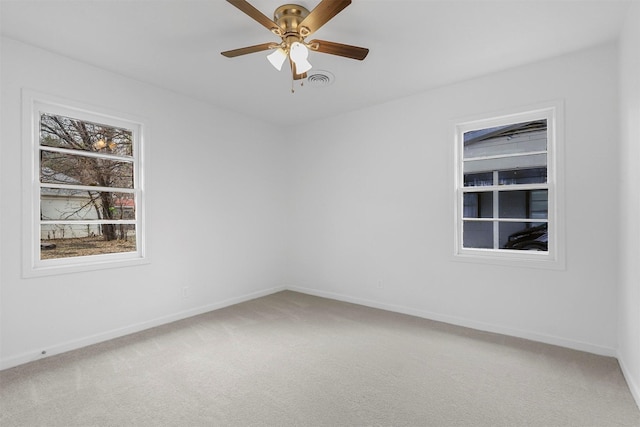 spare room with carpet and ceiling fan