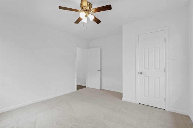 unfurnished bedroom featuring ceiling fan and light carpet