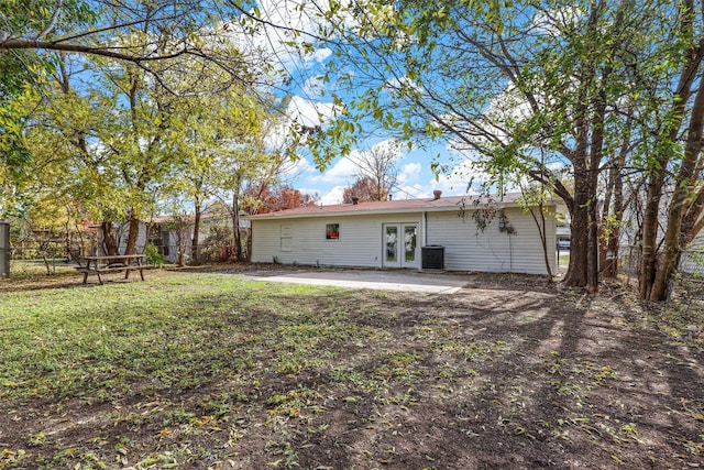 back of property featuring a patio, central AC unit, a lawn, and french doors