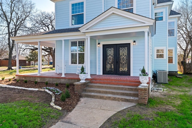 doorway to property featuring central AC, covered porch, and french doors