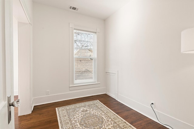 unfurnished room featuring dark hardwood / wood-style flooring