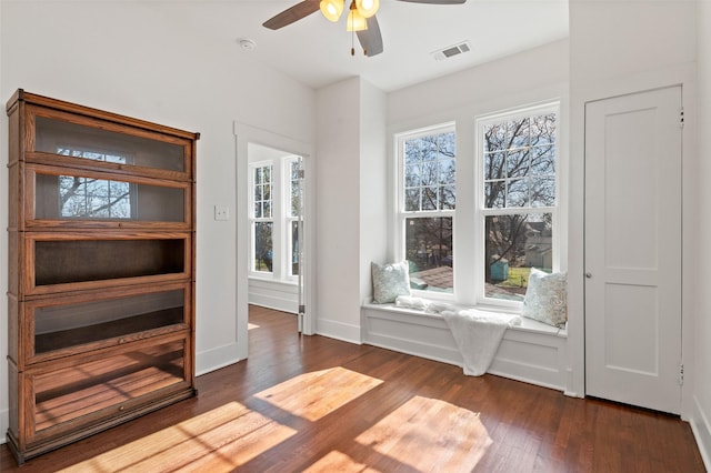 unfurnished room with ceiling fan and dark hardwood / wood-style flooring