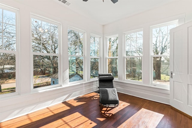 sunroom / solarium featuring ceiling fan