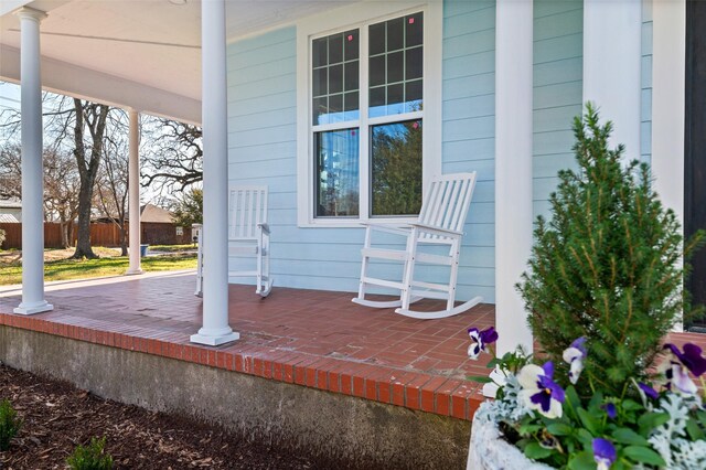 back of property featuring a porch and a yard