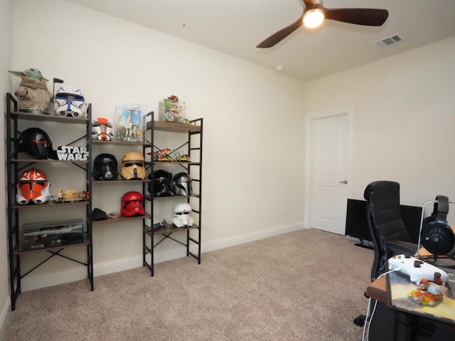 home office with light carpet and ceiling fan