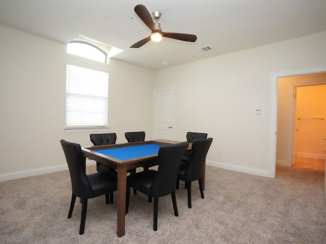 carpeted dining area featuring ceiling fan