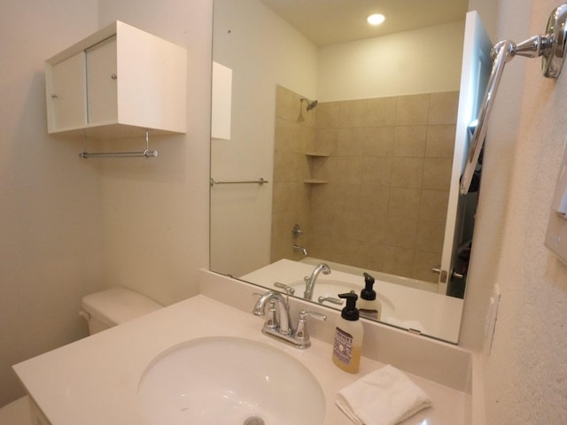 full bathroom featuring toilet, tiled shower / bath combo, and sink