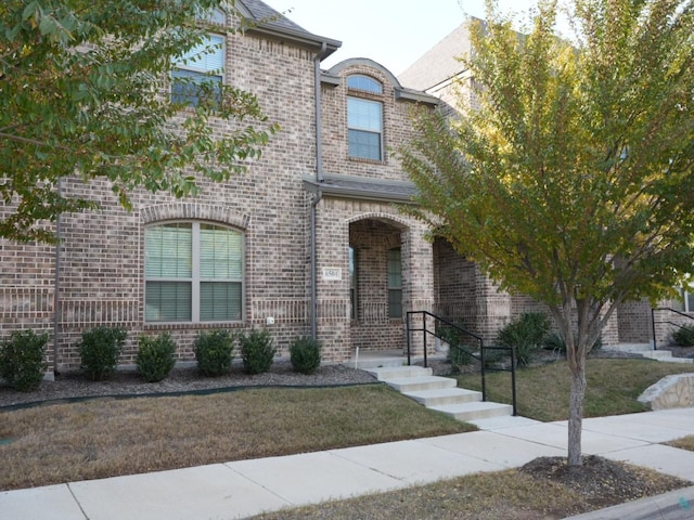 french country inspired facade with a front yard