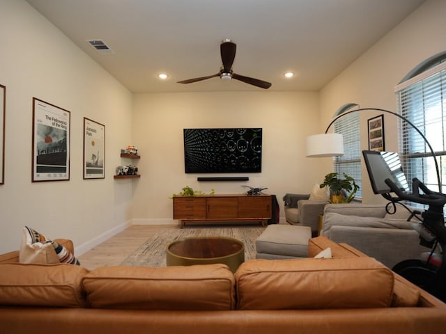 living room featuring ceiling fan and light wood-type flooring