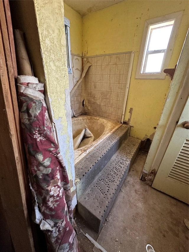 bathroom featuring a tub to relax in