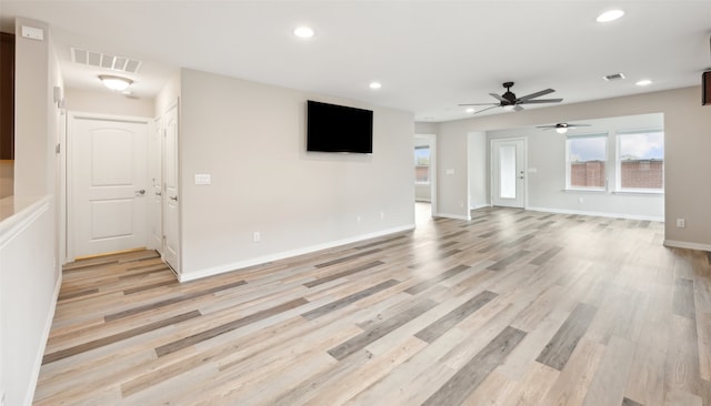 unfurnished living room featuring light hardwood / wood-style floors and ceiling fan