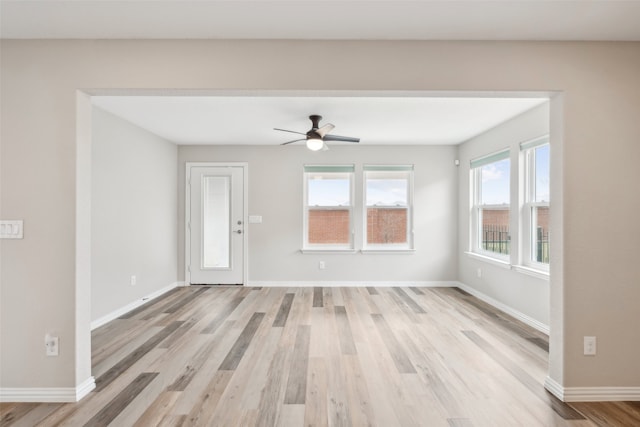 unfurnished living room with ceiling fan and light hardwood / wood-style floors