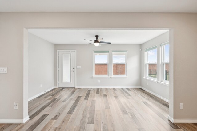 unfurnished living room featuring light hardwood / wood-style floors and ceiling fan