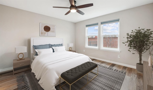 bedroom with hardwood / wood-style floors and ceiling fan