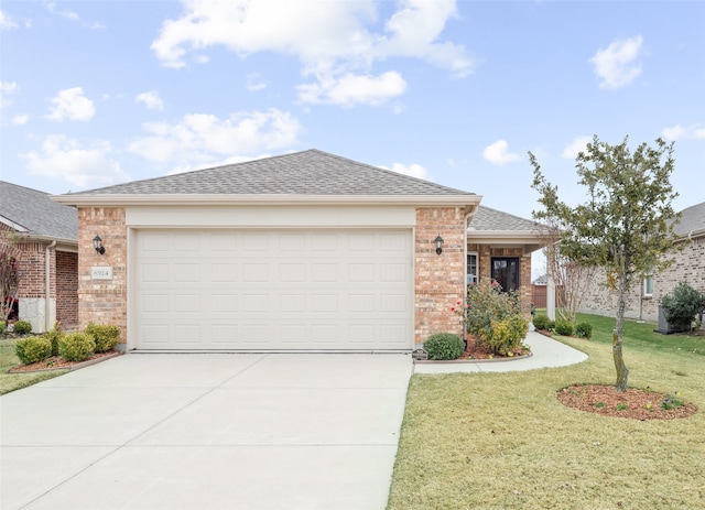 single story home featuring a garage, a front yard, concrete driveway, and brick siding