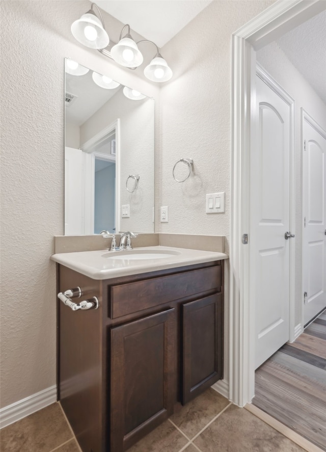 bathroom featuring vanity and wood-type flooring