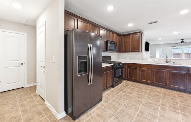 kitchen featuring ceiling fan, sink, dark brown cabinets, light tile patterned floors, and black appliances