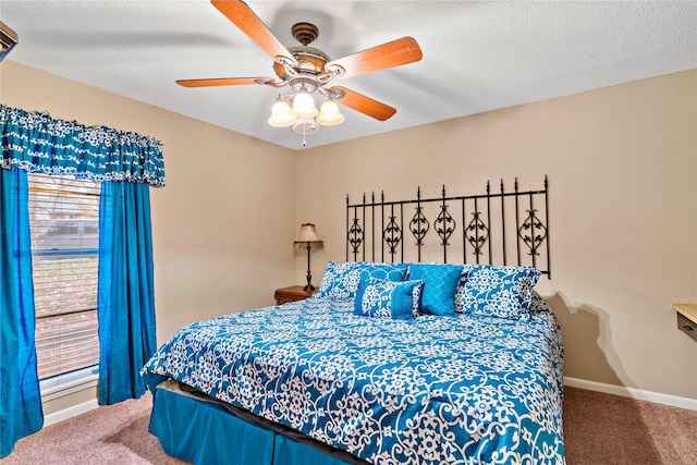 carpeted bedroom with ceiling fan and a textured ceiling