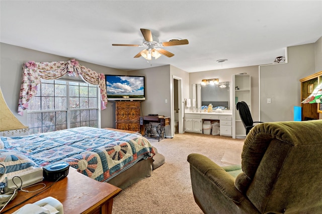 carpeted bedroom featuring ensuite bathroom and ceiling fan