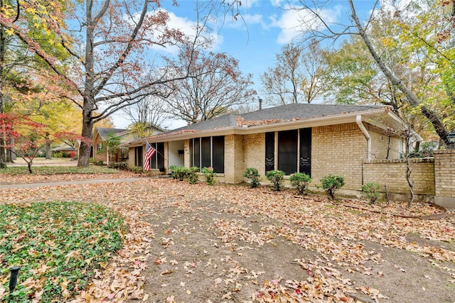 single story home featuring brick siding