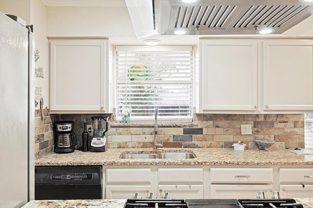 kitchen with sink, decorative backsplash, black dishwasher, light stone counters, and white cabinetry