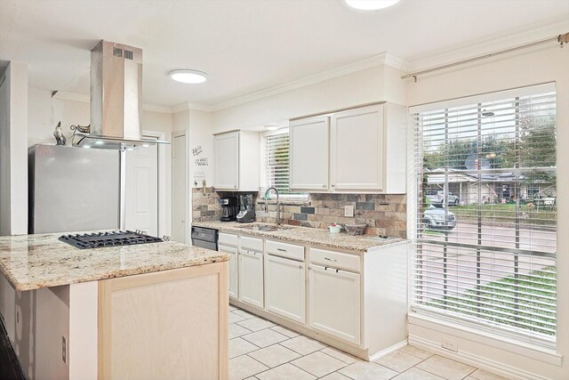 kitchen with island exhaust hood, light stone countertops, sink, white cabinets, and a kitchen island