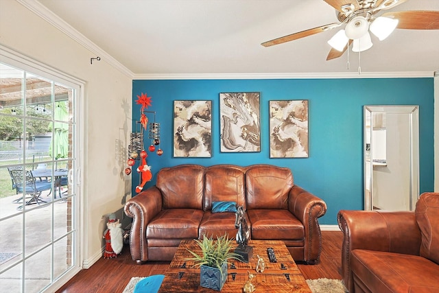 living room with dark hardwood / wood-style flooring, ceiling fan, and crown molding