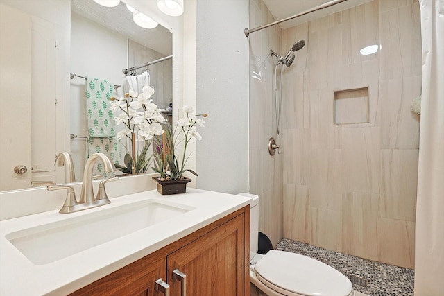 bathroom featuring vanity, toilet, and walk in shower