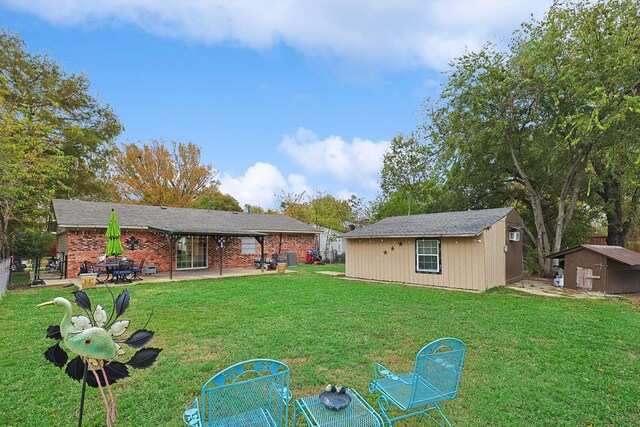 back of house with a lawn, a patio area, and a storage shed