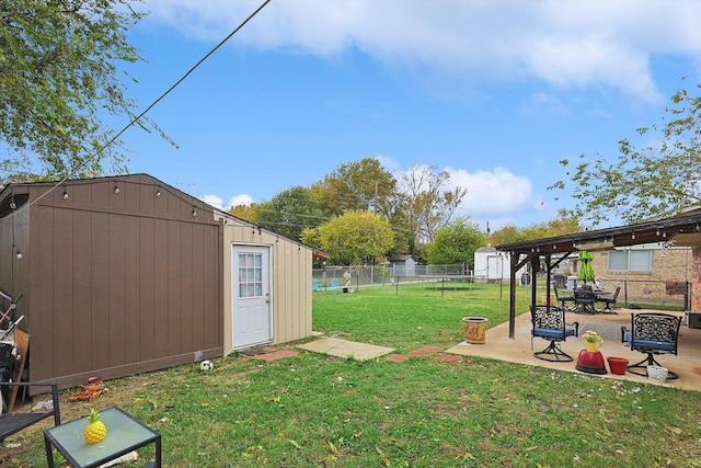 view of yard with a storage unit and a patio area